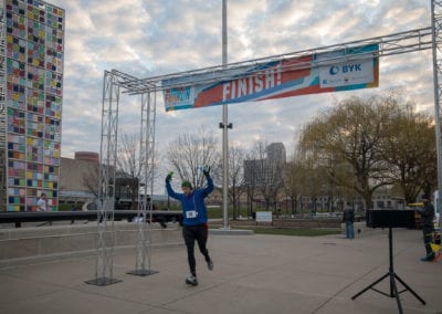 a person at finish line of the 2018 American Coatings Show Fun Run.