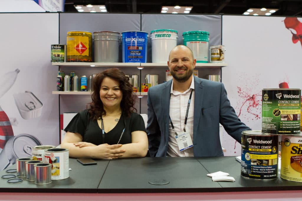 ACA_4-10-18_GWatson395 Photo of three people talking at booth at the American Coatings Show